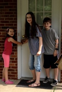 The kids stopped for one last picture as they closed the door on our old house.